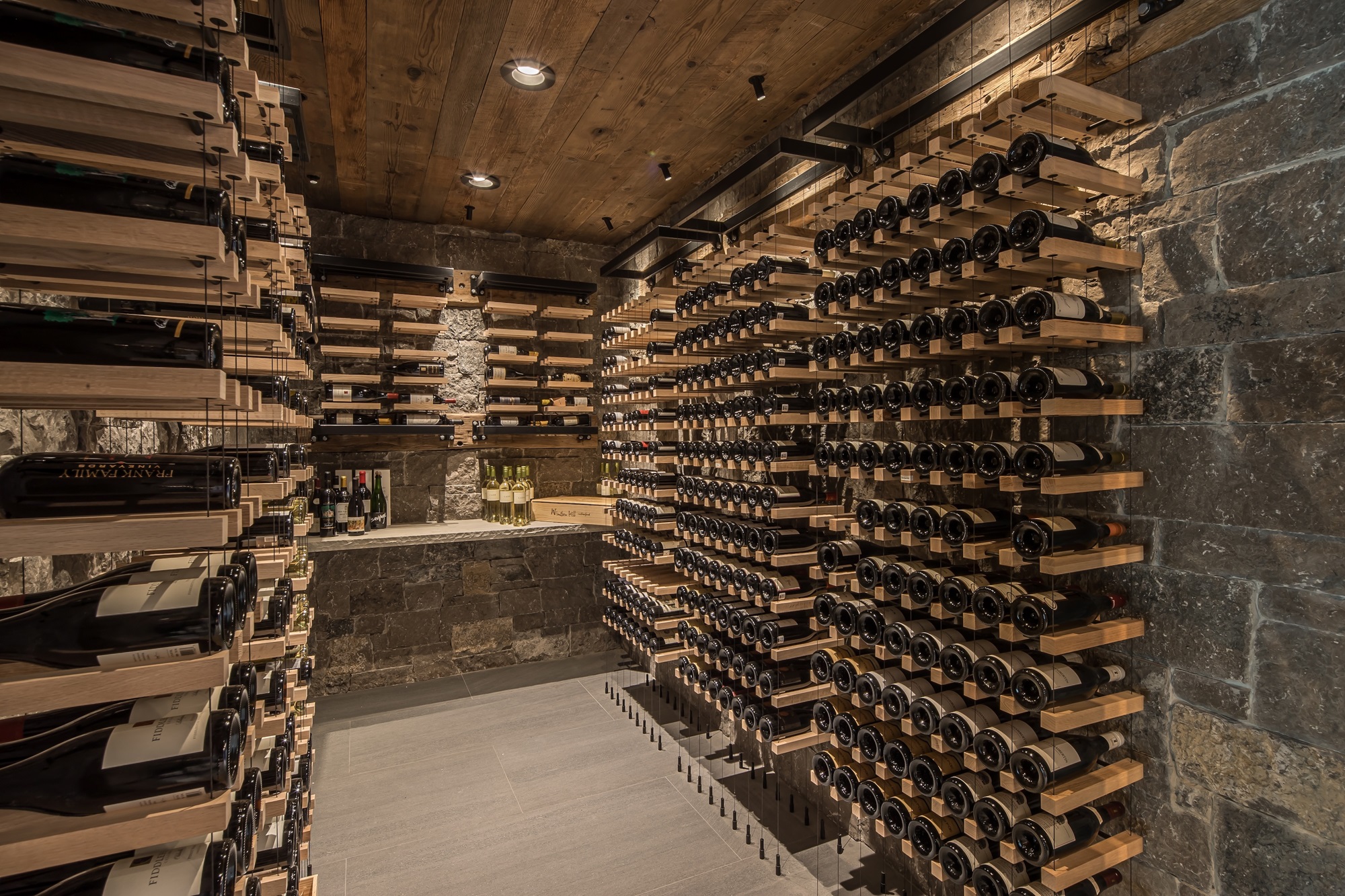 Luxury stone wine cellar with wooden racks Luxury stone wine cellar with wooden racks
