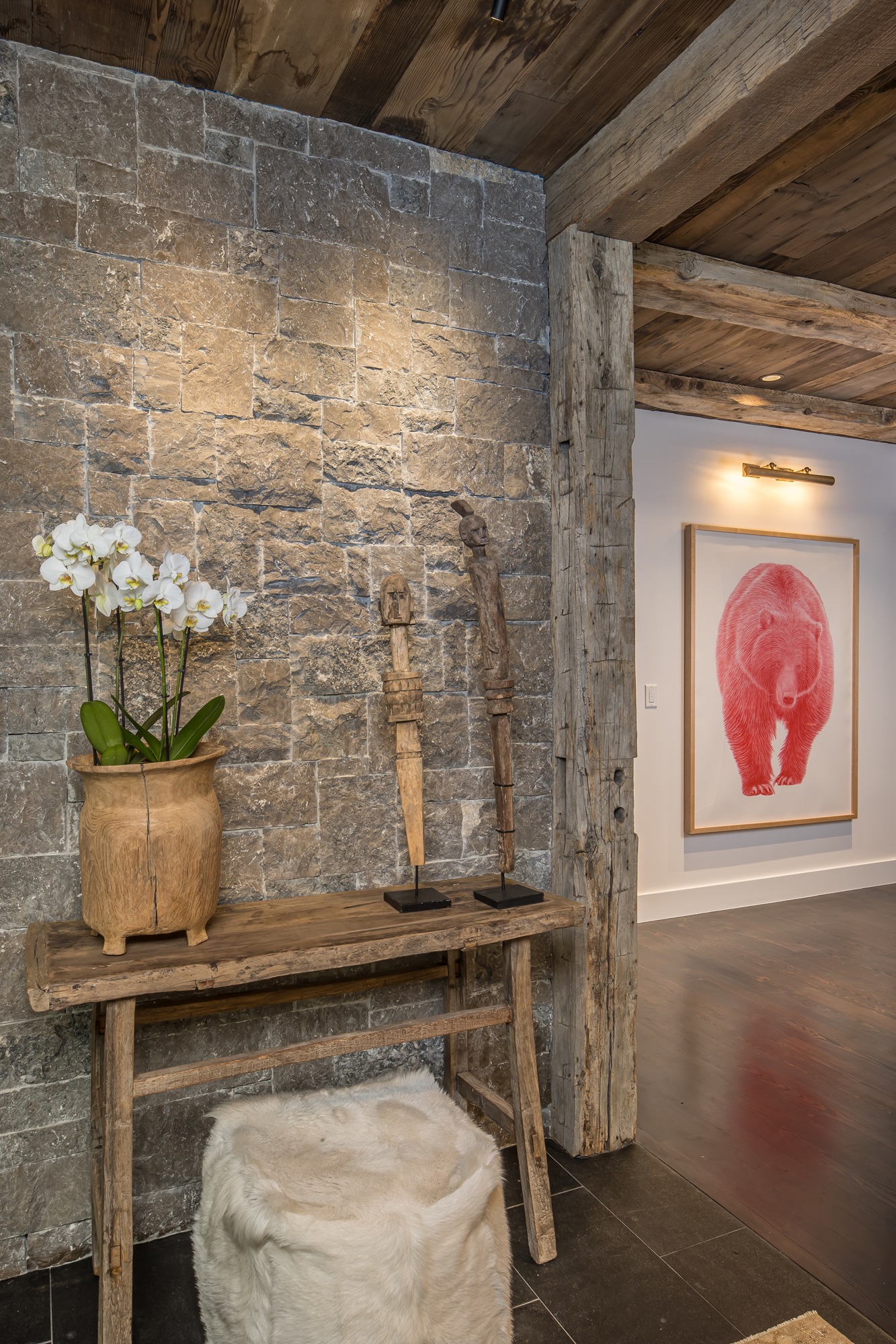 Rustic stone entry with orchid and bear art Rustic stone entry with orchid and bear art