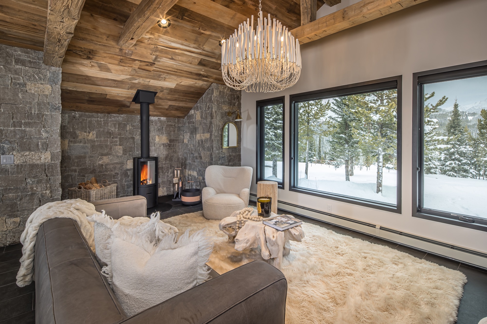 Cozy mountain lounge with fireplace and forest view Cozy mountain lounge with fireplace and forest view