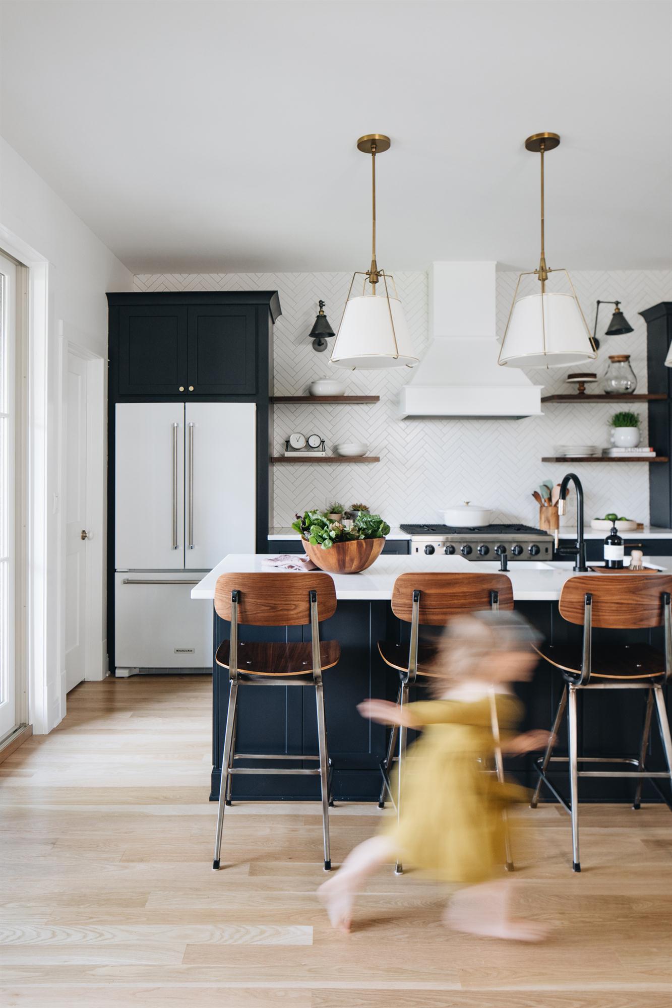 View of kitchen with child running